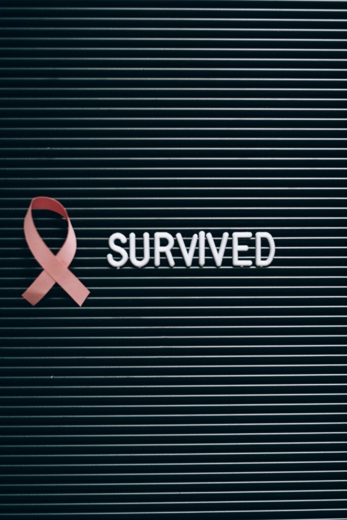 Cancer / Oncology Pink ribbon and 'SURVIVED' note symbolizing breast cancer awareness.
